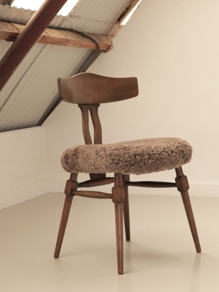 Recrafted dining chair from Design Preowned, restored using wool with circular and sustainable design focus.
