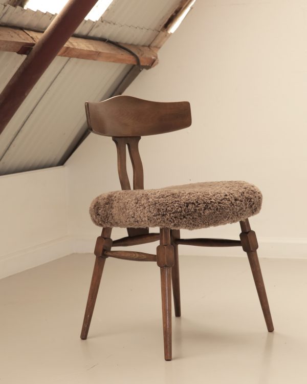 Recrafted dining chair from Design Preowned, restored using wool with circular and sustainable design focus.