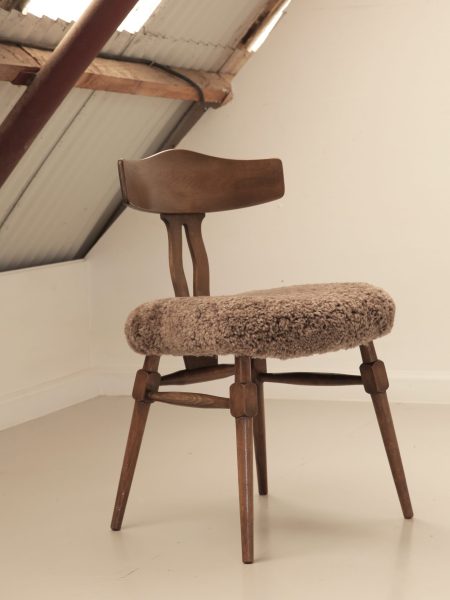 Recrafted dining chair from Design Preowned, restored using wool with circular and sustainable design focus.